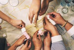 the hands of a group of people doing icebreaker activities
